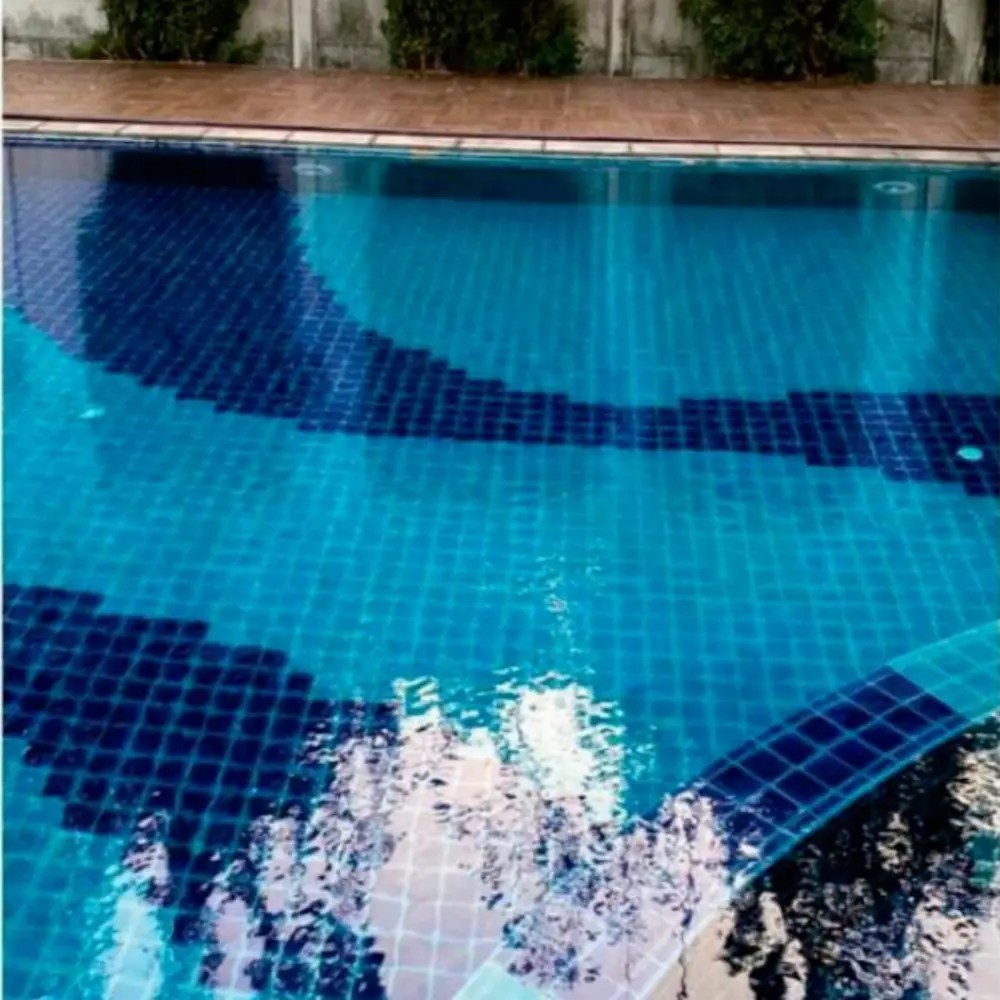 Blue mosaic swimming pool tiles in a finished outdoor pool